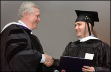 photo: Jack presents diploma to Luis